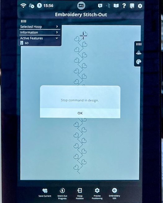 Embroidery Stitch-Out screen on the PFAFF creative icon 2 showing the beginning of the stitching process for a custom sequence created using Single Ribbon Stitch #8.1.6. The design is positioned in the center of the selected Elite Hoop 260 x 200 mm. The screen displays a pop-up message reading “Stop command in design,” which appears automatically when the machine pauses to allow thread cutting or ribbon placement. The active feature listed is 6D, and the full-color interface shows precise needle positioning before resuming embroidery.