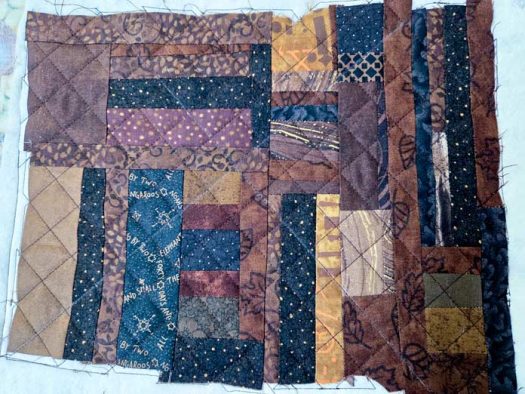 Grid quilt lines on scrappy, brown fabric