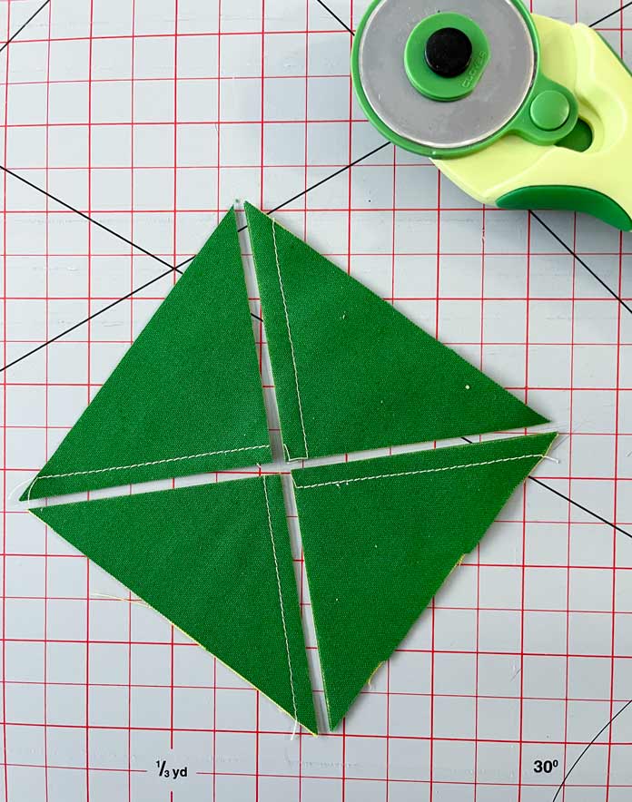 The paired squares are cut along the marked diagonal lines resulting in four triangular units. Clover Thread Cutter Pendant, Clover Chaco Liner, Clover Quilting Pins