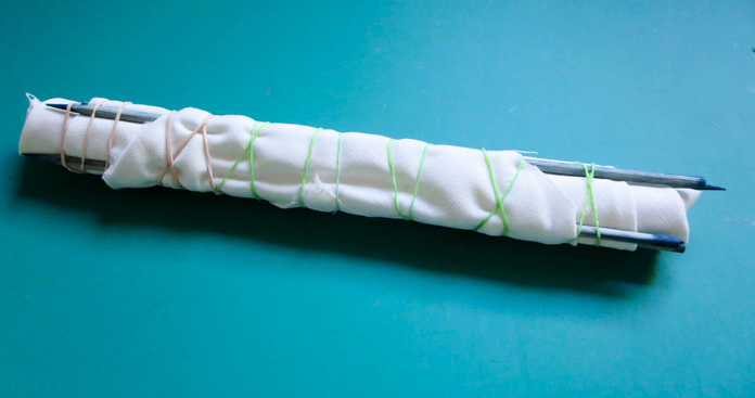 Fabric is wrapped around several skewers and secured with rubber bands