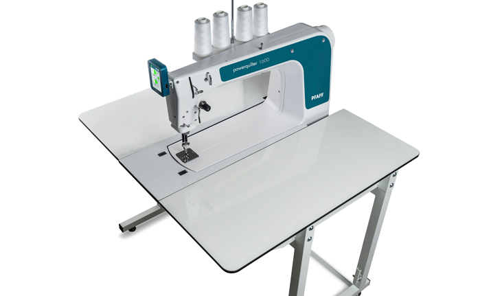 A white and teal sit-down quilting machine on a white table; PFAFF powerquilter 1600