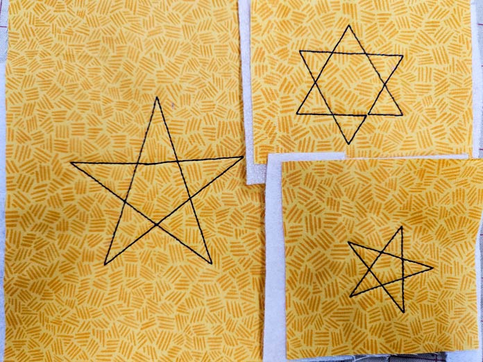 Star outlines on yellow fabric