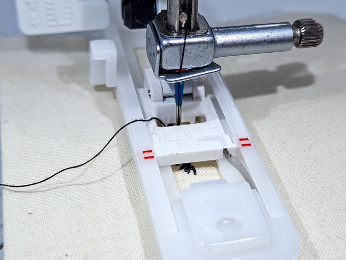 A white buttonhole foot on a sewing machine; Husqvarna VIKING Designer Quartz 29