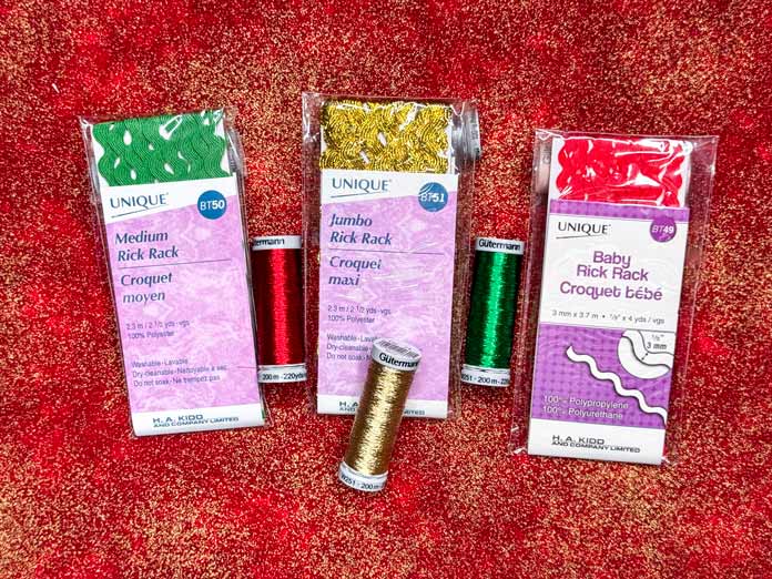 Three spools of Gütermann Metallic Thread and three packages of Rick Rack, a Green, gold and red of each. 