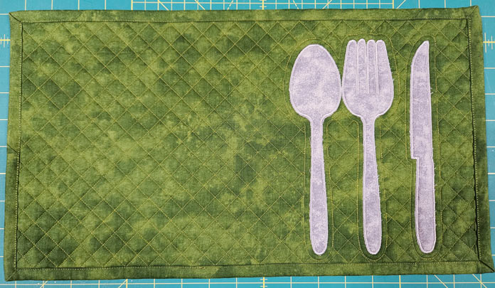 Silver spoon, fork, and knife on green fabric; machine embroidery, quilting, mySewnet, HUSQVARNA VIKING, embroidery software, digital embroidery, quilt block wizard, applique, embroidery design, monogramming