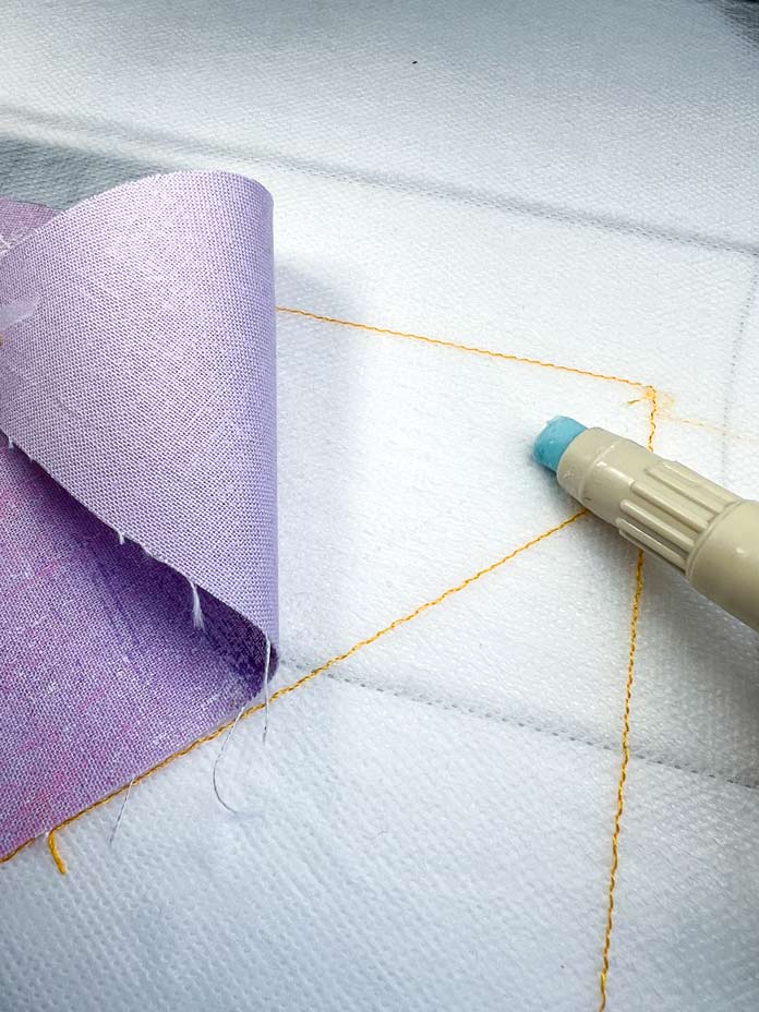Placing and temporary gluing process of the first piece of patchwork block 1 with PFAFF 6D Dynamic Spring Foot 