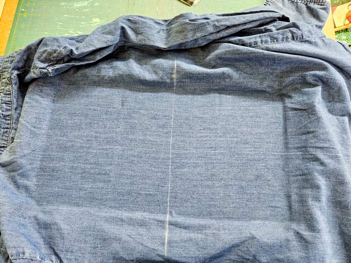 A denim shirt in a machine embroidery hoop