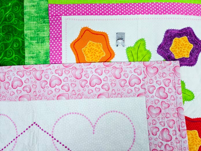 Brightly colored fabrics with decorative stitching