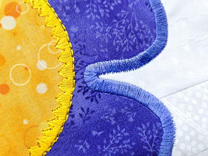 Yellow and purple stitching on yellow and purple fabrics