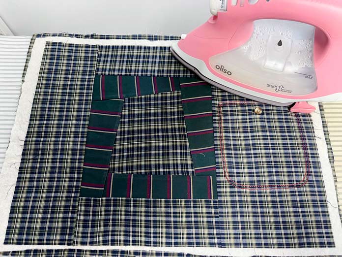 Backing, batting and placemat top are layered using spray adhesive and ready to be pressed; OMNIGRIP Ruler 8½" x 8½", OLFA 45 mm Ergonomic Rotary Cutter, OLFA Endurance Rotary Blades, Sulky Tear-Easy stabilizer, Odif 505 Adhesive Fabric Spray, OLISO PRO TG1600 Pro Plus Smart Iron, Mary Ellen’s Best Press, Best Press Spray and Misting Bottle