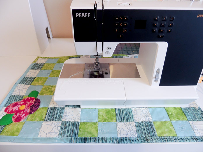 PFAFF passport 2.0 on a sewing table with the spring table topper underneath