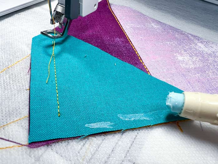 Process of gluing the seam allowance of the piece for better placement of the fabric with a glue pen 