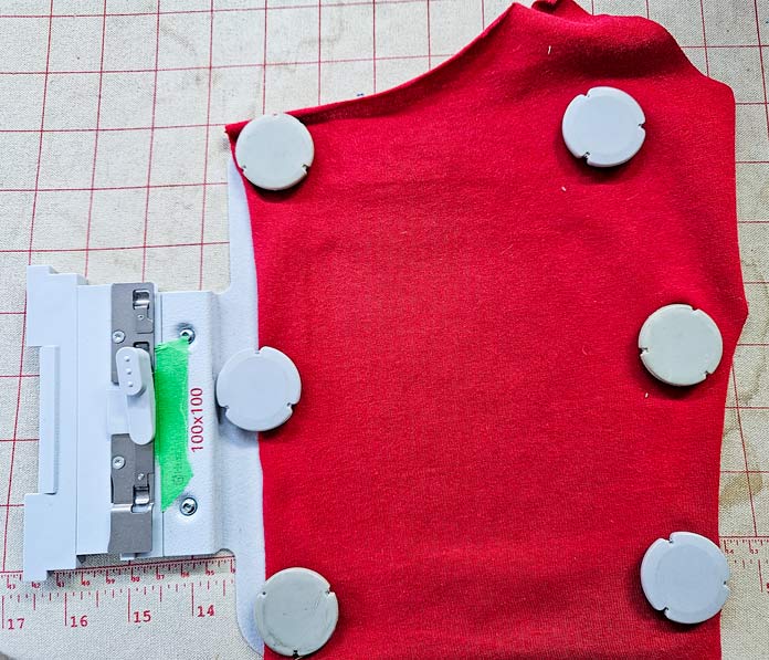 Red fabric in a metal embroidery hoop