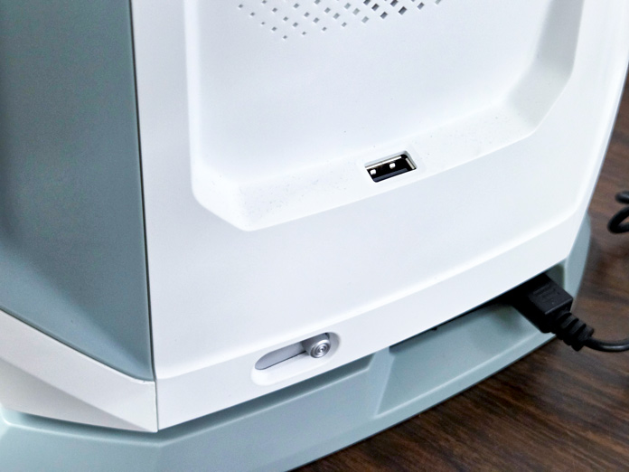 A USB port on a white sewing machine