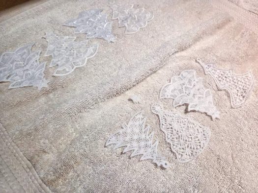 White lace ornaments on a white towel; Gütermann cotton thread