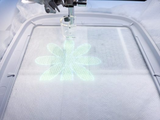 A flower projected on a white piece of stabilizer