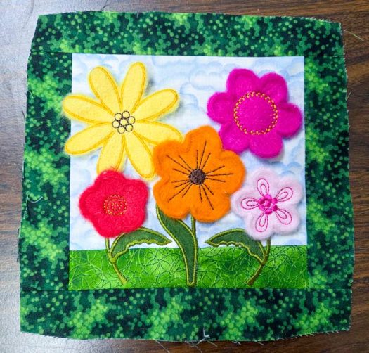 Brightly colored machine-embroidered felted flowers