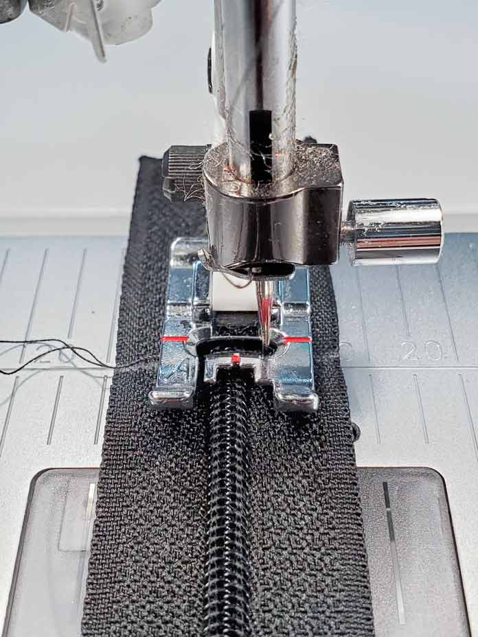 A metal sewing machine foot sewing a tacking stitch on a sewing machine. Husqvarna Viking Designer Sapphire 85, Inspira EZ Snip Curved Scissors