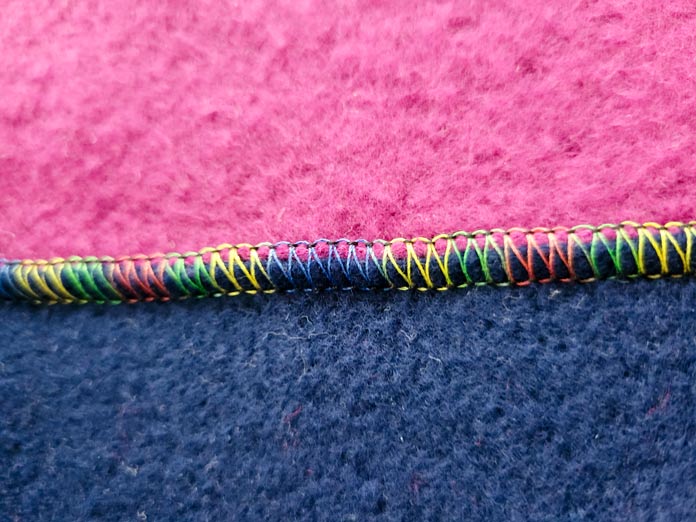 A variegated thread on blue and pink fleece