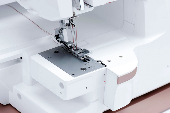 A large work area on a white serger; Husqvarna Viking Amber Air S600