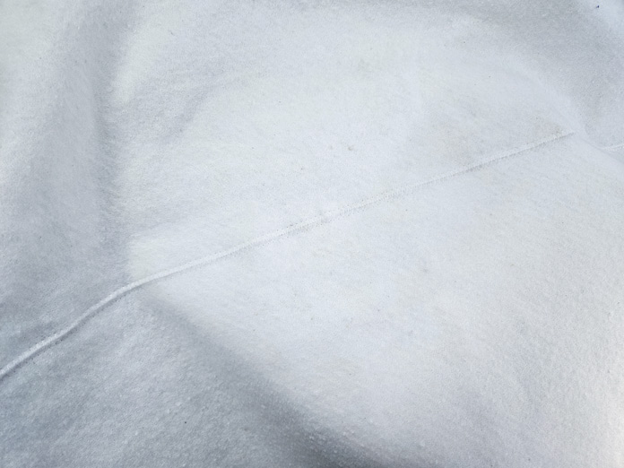 A large piece of white batting with a seam in the middle