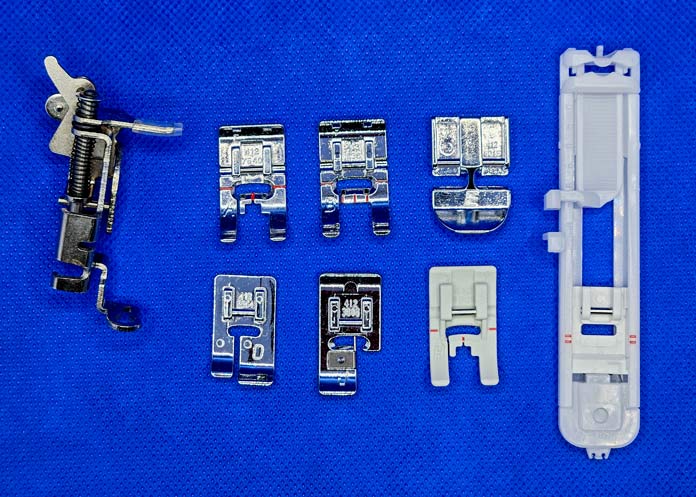 A variety of metal and plastic presser feet for a sewing machine; Husqvarna VIKING Designer Quartz 29, mySewnet Machine Embroidery Software