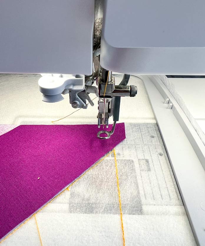 Hooped patchwork block 1 with stitching in process with PFAFF 6D Dynamic Spring Foot Placing and loss of the top thread 