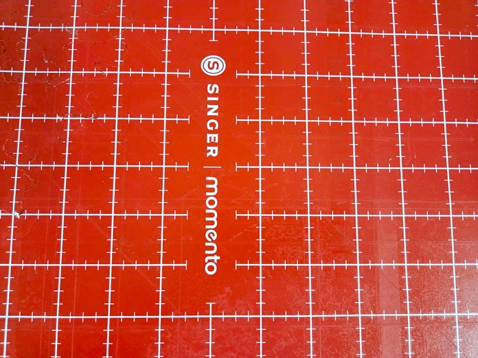 A red digital cutter mat