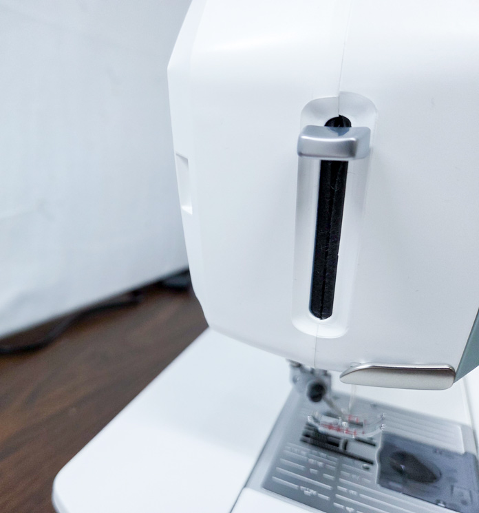 A needle threader on a sewing machine