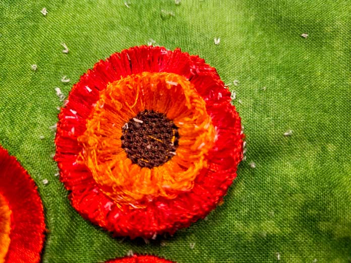 An orange and gold machine embroidery flower