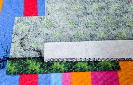 Green fabric on a brightly colored pressing surface