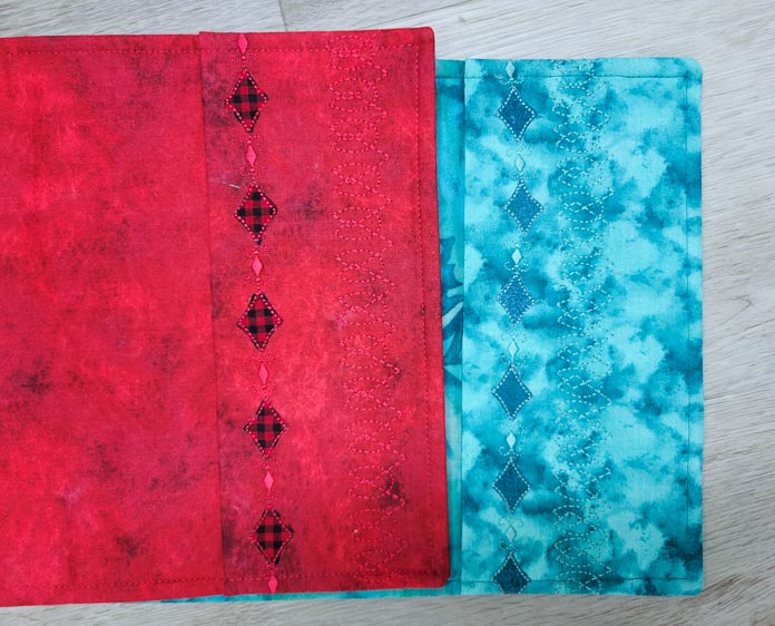 Red fabric with black and red accents, teal fabric with teal stitched accents