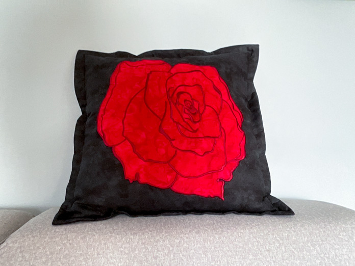 Finished Rose Applique cushion with a narrow flange edge.