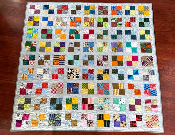 The completed quilt with a total of 81 blocks each containing four 3 squares