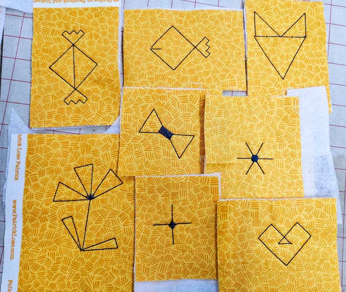 Outlines of various shapes on yellow fabric