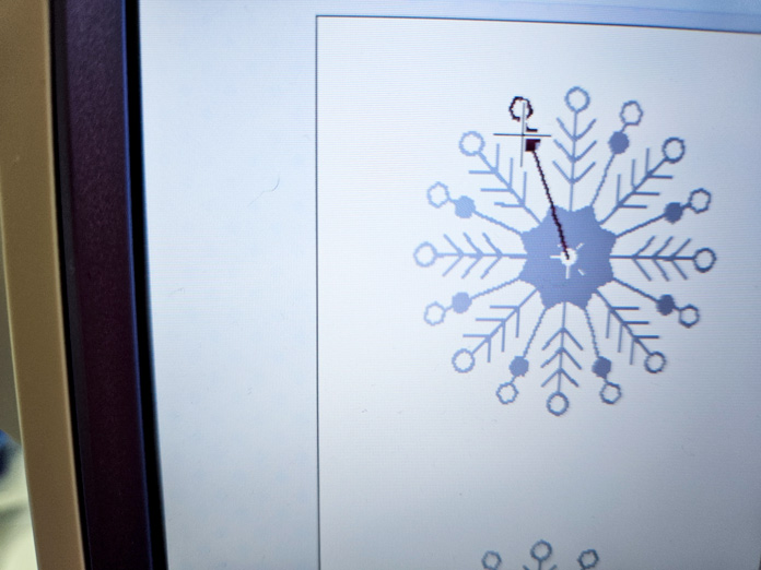 A snowflake on the screen of a computerized sewing and embroidery machine; Husqvarna VIKING Designer Quartz 29, mySewnet Machine Embroidery Software, mySewnet Library, Husqvarna VIKING Tear-a-Way Light Stabilizer 15 Inches x 25 Yards