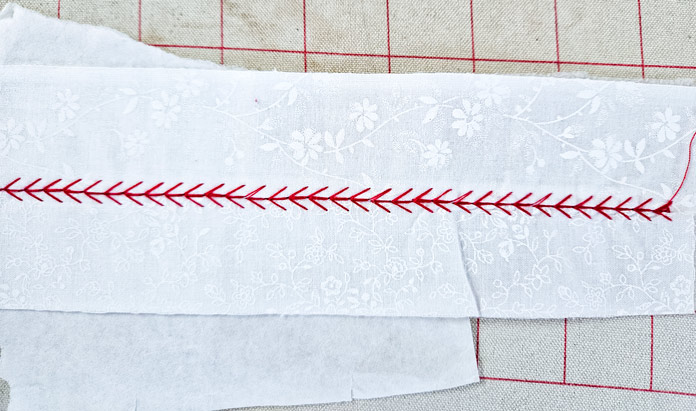 Red stitching on white fabric