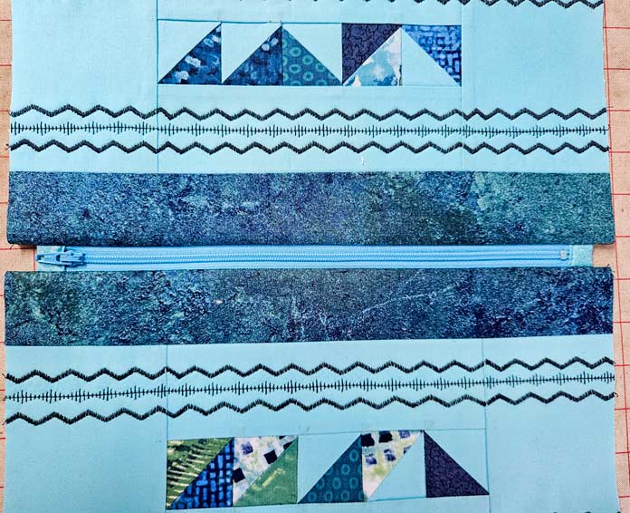 A blue zipper in blue fabric