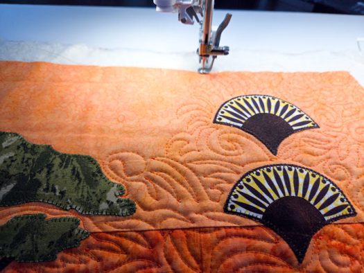 Lines of orange stitching on orange fabric