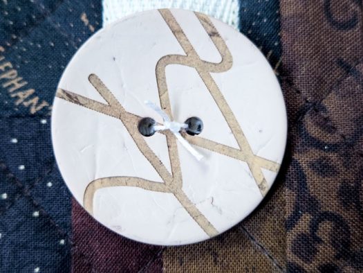 A button with a knot in the center