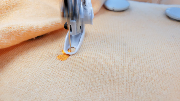 Machine embroidering an orange design on an orange knit; Husqvarna Viking Designer Ruby 90, Small Metal Hoop (100m x 100m), Inspira Magnets for Metal Hoop