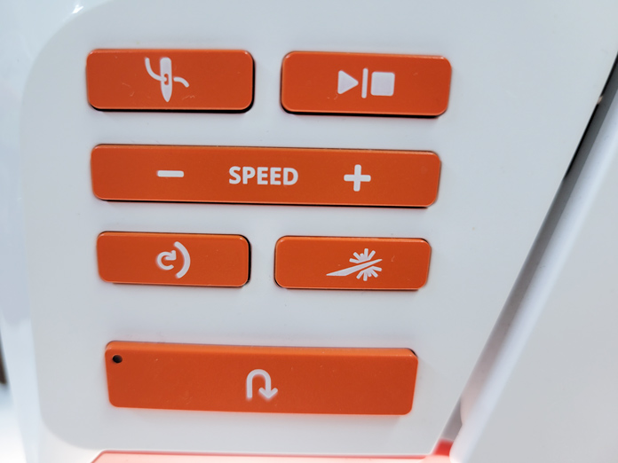 Orange buttons on a function panel on a white sewing machine; Husqvarna Viking Designer EPIC 2