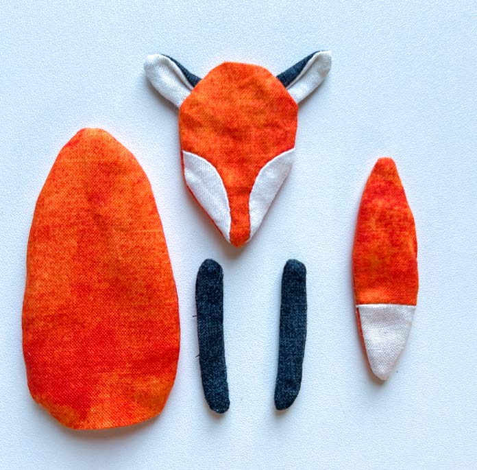 Finished and pressed parts of a small fabric toy fox before stuffing. PFAFF creative icon 2, PFAFF creative icon 2 sewing and embroidery machine, PFAFF Universal Needles Size 80/12, PFAFF Universal Needles Size 90/14, PFAFF Quilting Needles Size 90/14, PFAFF ¼” Quilting Foot for IDT System, Mettler 40wt polyester thread, oliso iron