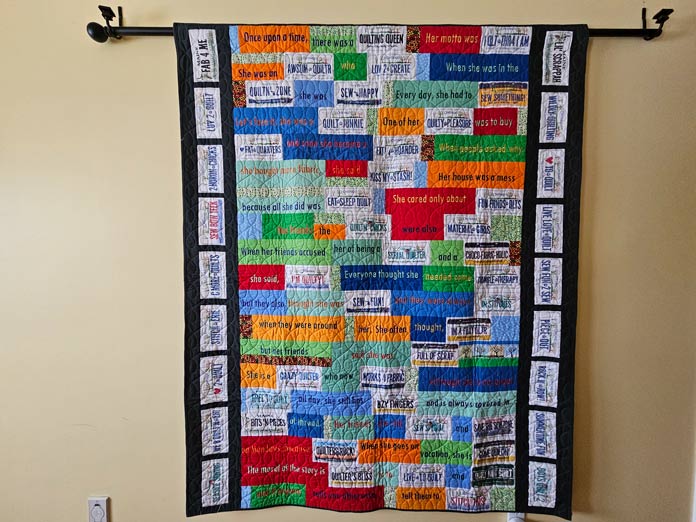 A multi-color quilt hanging on a wall; quilting, embroidery machine, machine embroidery, quilting techniques, Husqvarna VIKING, quilt labels, embroidery software, quilt embellishments, quilting tools, QUILTsocial, Husqvarna VIKING Designer Epic 3, Designer Epic 3