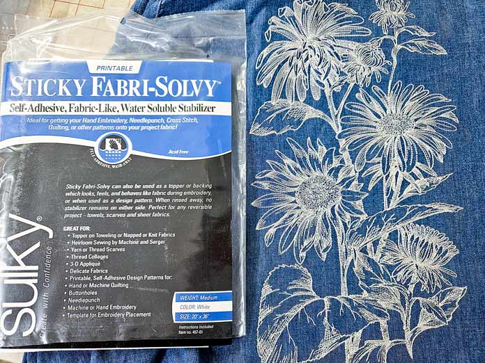 A white floral design on a blue denim