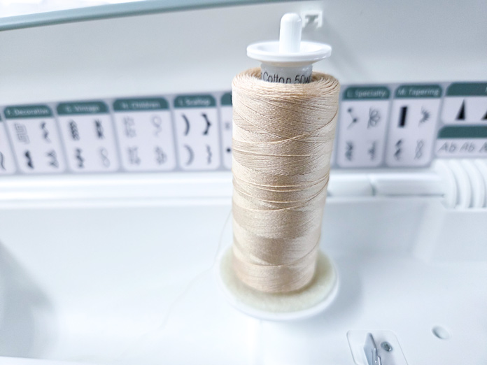 The incorrect use of a spool cap on a vertical spool of thread
