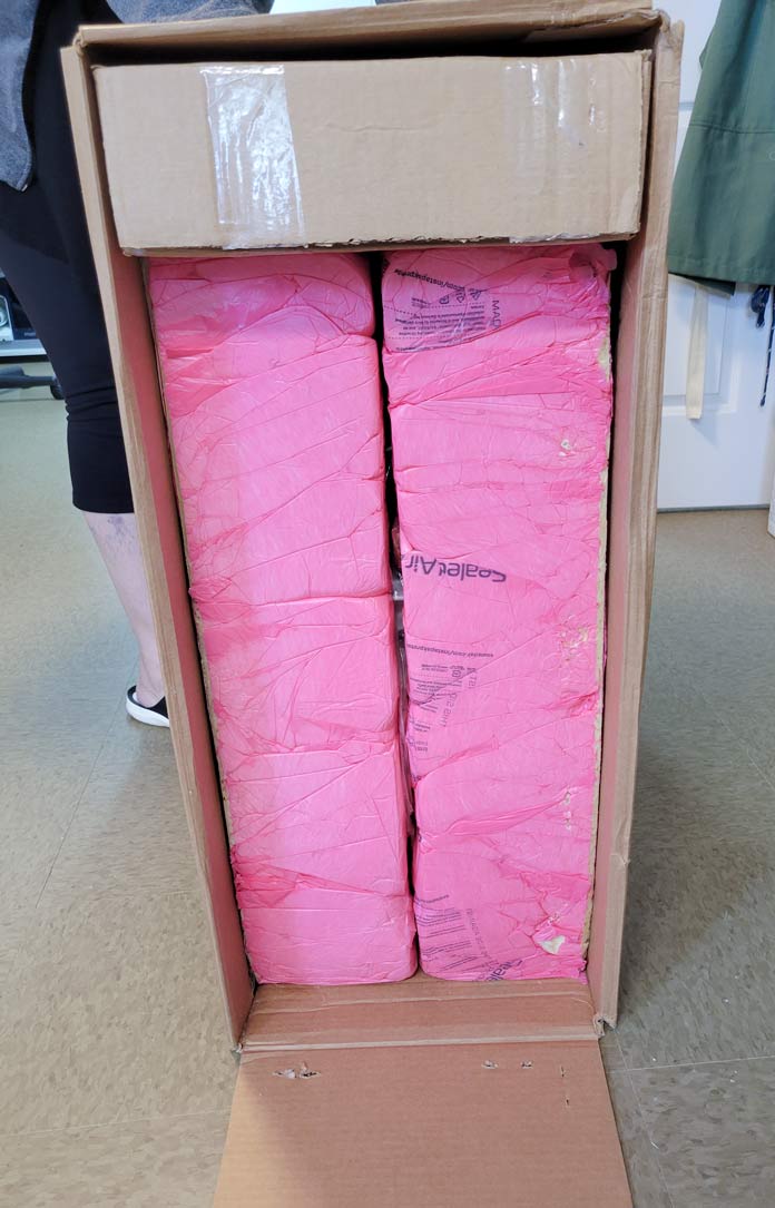 A cardboard box with pink foam