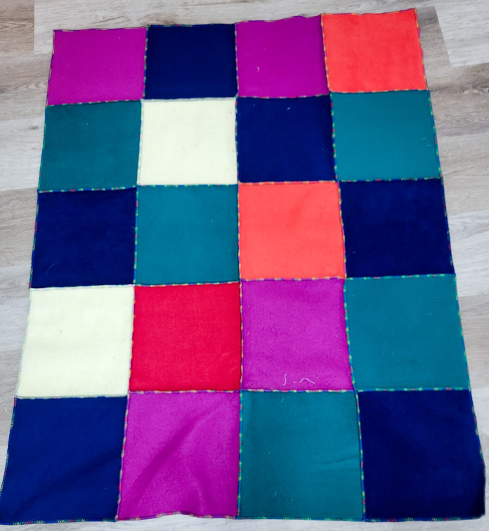A multi-color blanket of fleece squares