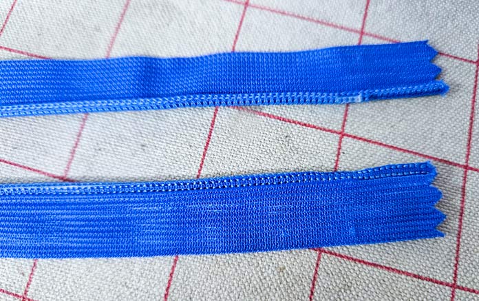 Two blue strips of zipper; Gütermann Nostalgia Box - 50wt Cotton Thread 100m - 48 Shades, Gütermann Nostalgia Box, Flat Felled Foot 9mm, Husqvarna VIKING Opal 690Q, free sewing pattern, outdoor accessories, outdoor cushions, piping, Husqvarna VIKING 8” Bent Trimmer