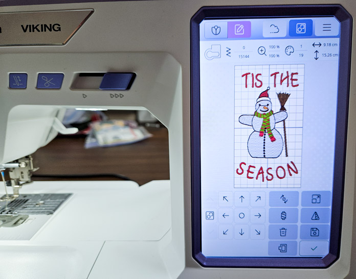 A snowman and red lettering on the screen of a computerized embroidery machine; Husqvarna VIKING Designer Quartz 29, mySewnet Machine Embroidery Software, Husqvarna VIKING Tear-a-Way Light Stabilizer 15 Inches x 25 Yards